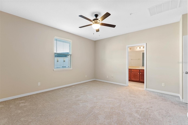 carpeted spare room featuring ceiling fan