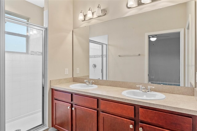 bathroom with ceiling fan, vanity, and a shower with shower door