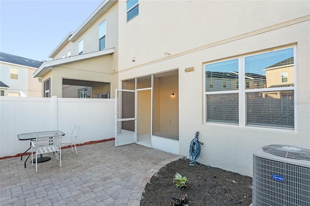 view of patio / terrace featuring a sunroom and cooling unit