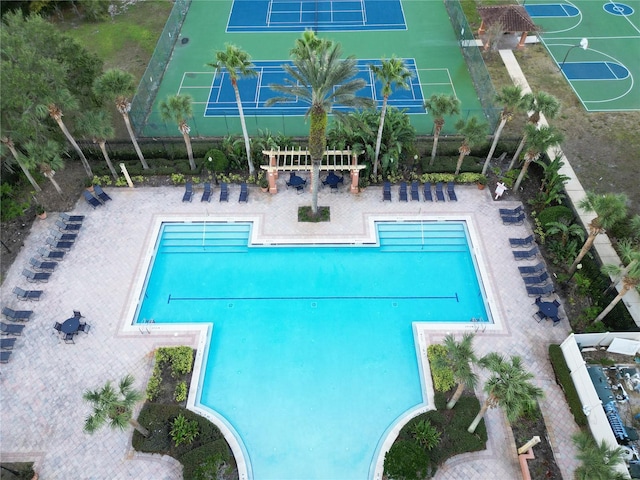 view of pool featuring tennis court