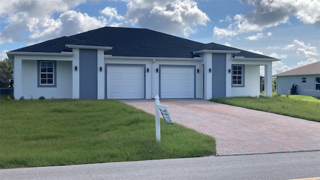 view of front of home with a garage and a front lawn