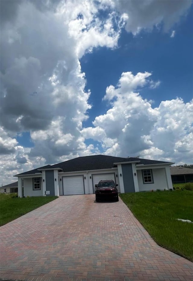 ranch-style house with a garage and a front yard