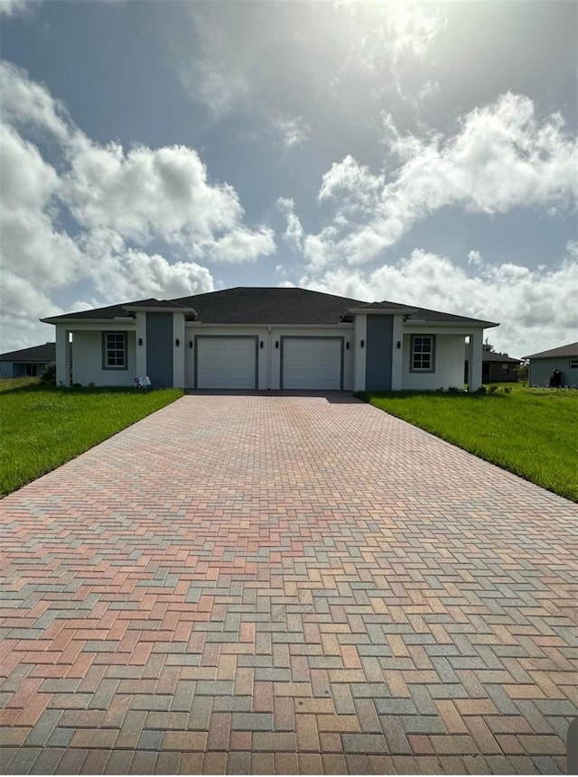 ranch-style house featuring a garage and a front lawn