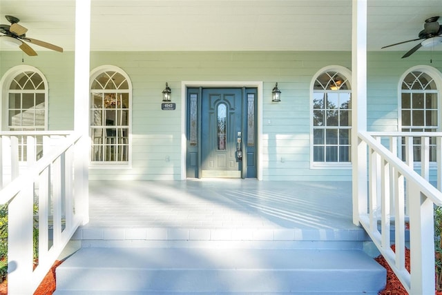 view of exterior entry with covered porch and ceiling fan