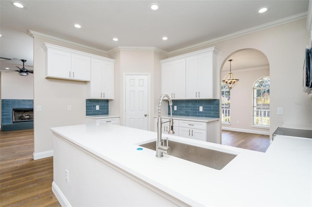 kitchen featuring white cabinetry, sink, dark wood-type flooring, and ceiling fan with notable chandelier