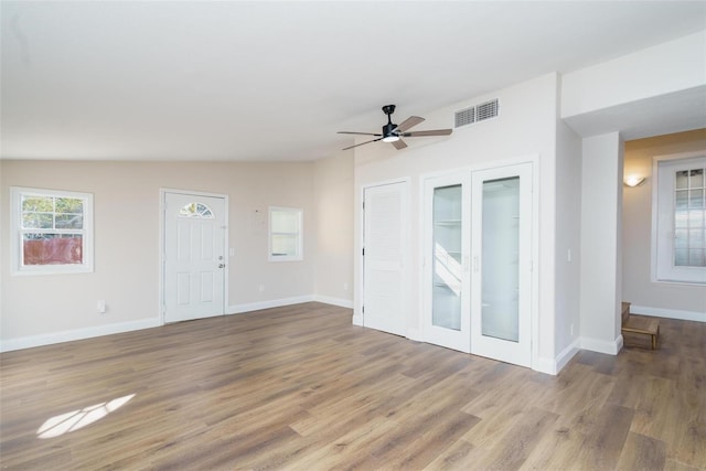 unfurnished living room featuring hardwood / wood-style floors, ceiling fan, and lofted ceiling