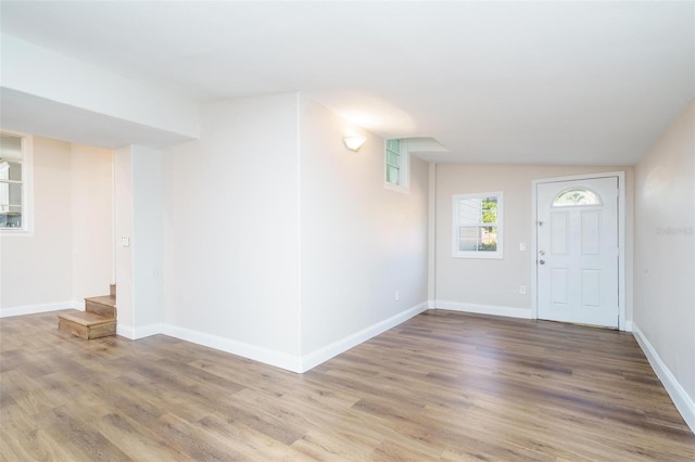 foyer entrance with hardwood / wood-style floors and lofted ceiling