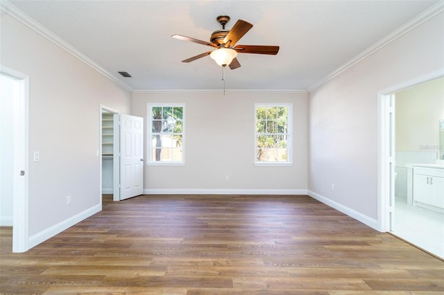 spare room with ceiling fan, ornamental molding, and hardwood / wood-style flooring