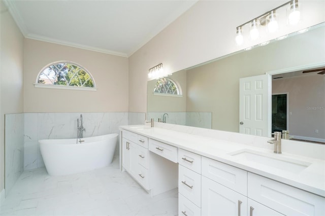 bathroom featuring vanity, a tub, tile walls, and ornamental molding