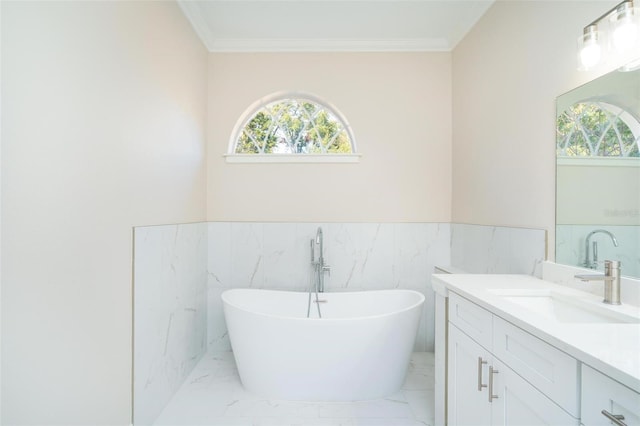 bathroom featuring vanity, crown molding, tile walls, and a bathing tub