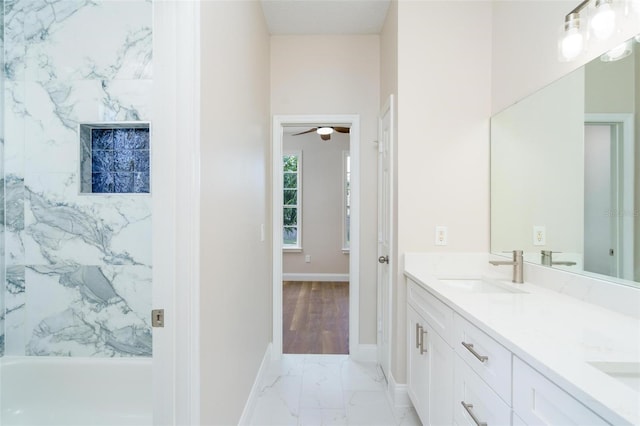 bathroom featuring vanity, ceiling fan, and tub / shower combination