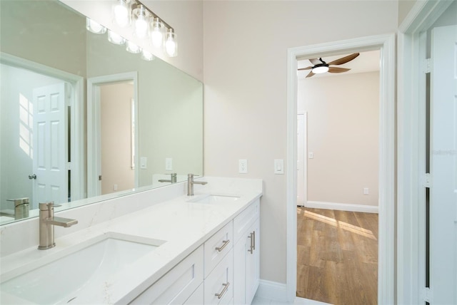 bathroom featuring ceiling fan, hardwood / wood-style floors, and vanity