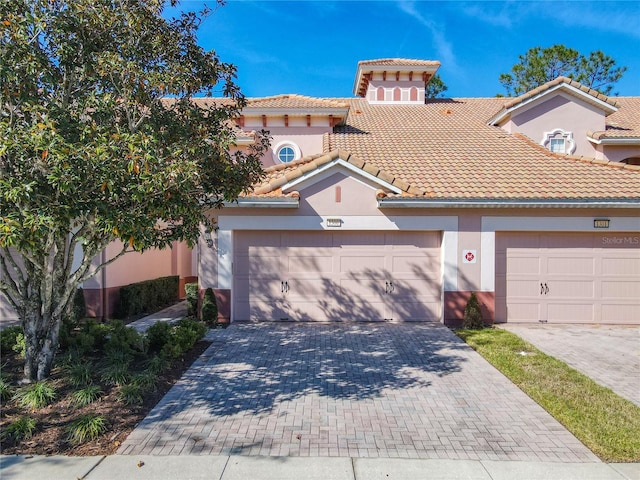 mediterranean / spanish home with a garage