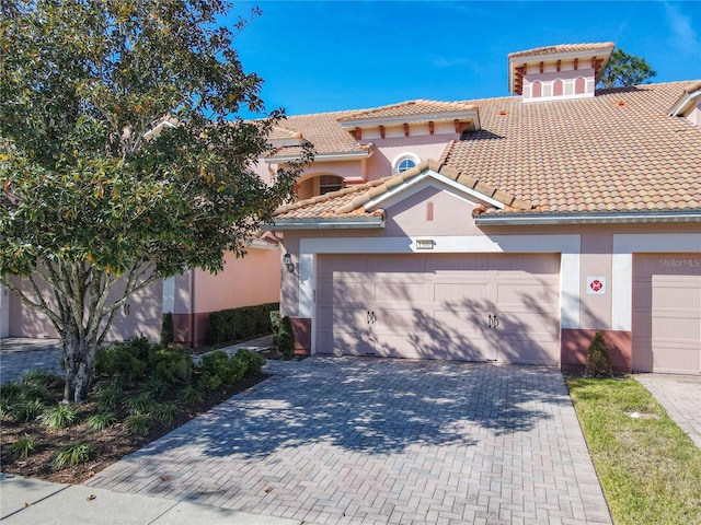 1300 Gilford Point Ln Unit 1300, Davenport, FL 33896 - mediterranean / spanish house with driveway, an attached garage, stucco siding, and a tiled roof