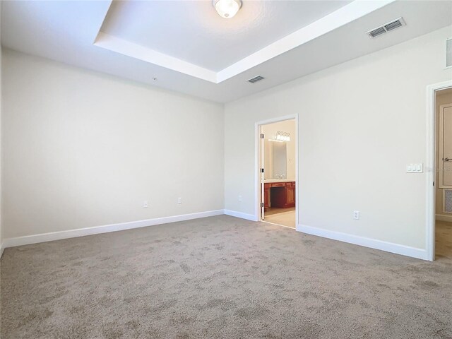 1300 Gilford Point Ln Unit 1300, Davenport, FL 33896 - unfurnished bedroom with carpet floors, a raised ceiling, and connected bathroom