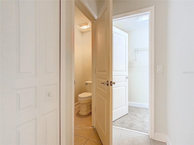 bathroom featuring toilet and tile patterned floors