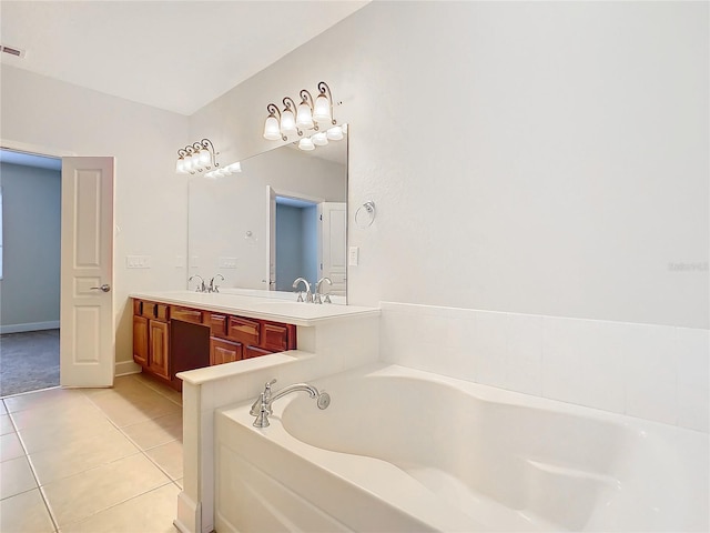 bathroom featuring tile patterned floors, a bathing tub, vanity, and vaulted ceiling