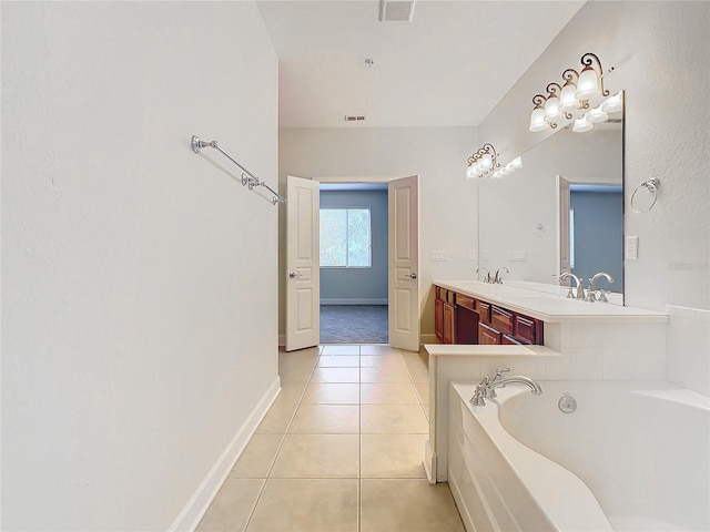 bathroom featuring a washtub, vanity, and tile patterned floors