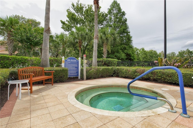 view of swimming pool with a community hot tub