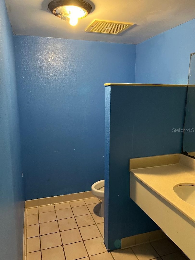 bathroom featuring tile patterned floors, vanity, and toilet