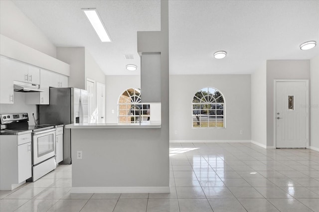 kitchen with light tile patterned flooring, stainless steel appliances, a textured ceiling, and white cabinets