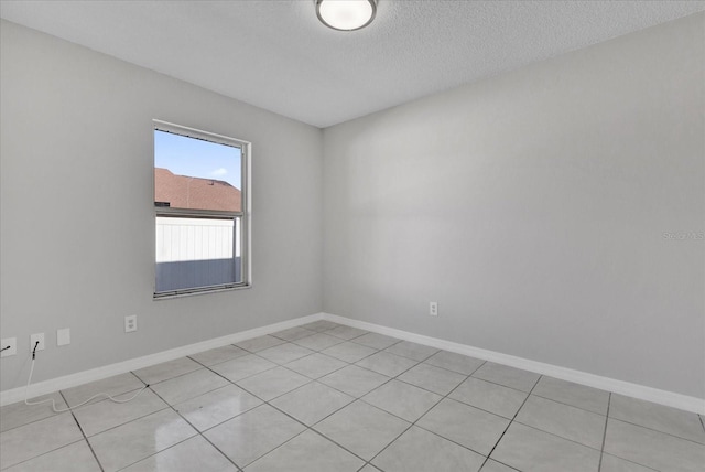 unfurnished room with a textured ceiling