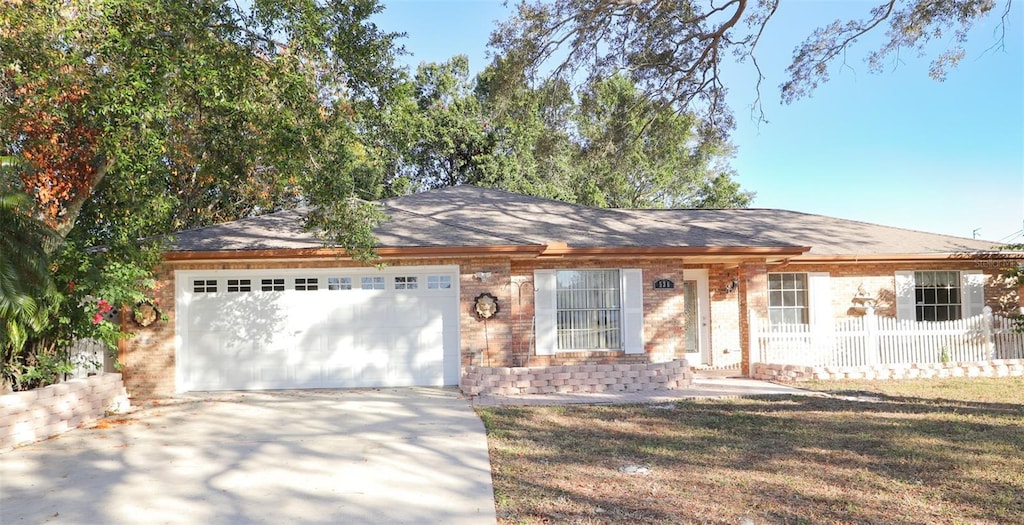 ranch-style home with a front lawn and a garage