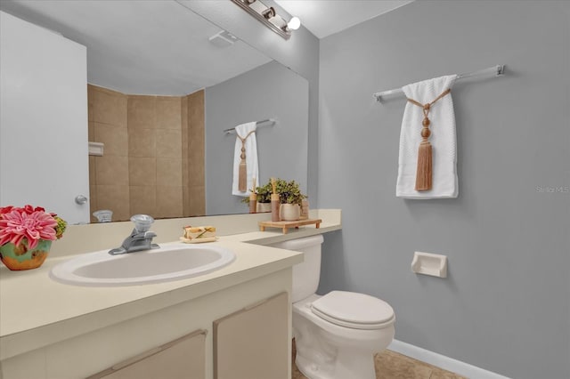 bathroom with tile patterned flooring, vanity, and toilet