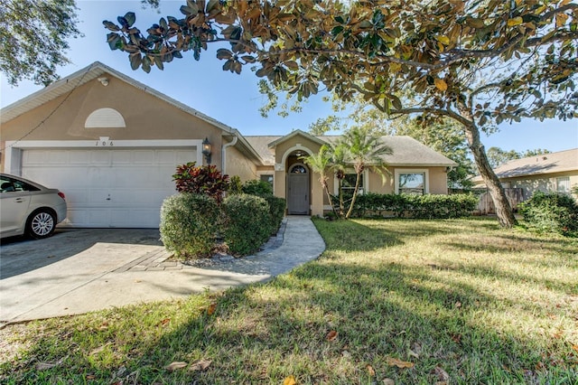 ranch-style house featuring a front lawn and a garage