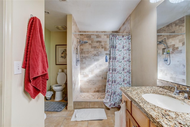 bathroom with tile patterned flooring, vanity, a shower with shower curtain, and toilet