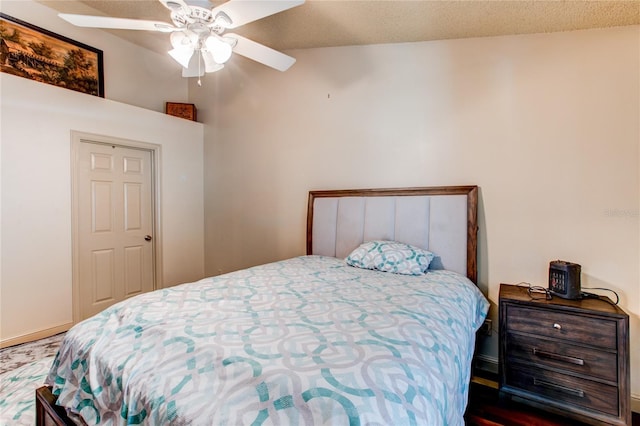 bedroom featuring ceiling fan, high vaulted ceiling, and a textured ceiling