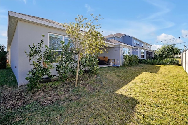 3359 Hanging Tide St, Winter Garden, FL 34787 - rear view of property with stucco siding, a lawn, and a patio area