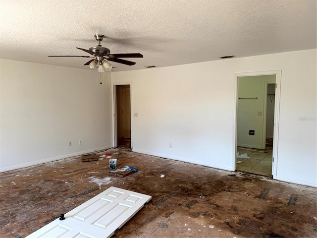 empty room featuring a textured ceiling and ceiling fan