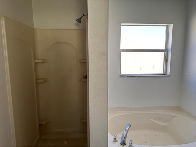 bathroom featuring shower with separate bathtub