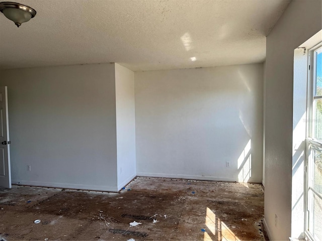 spare room with a textured ceiling