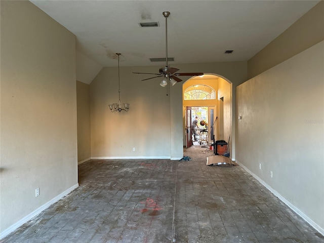 spare room with ceiling fan with notable chandelier and vaulted ceiling