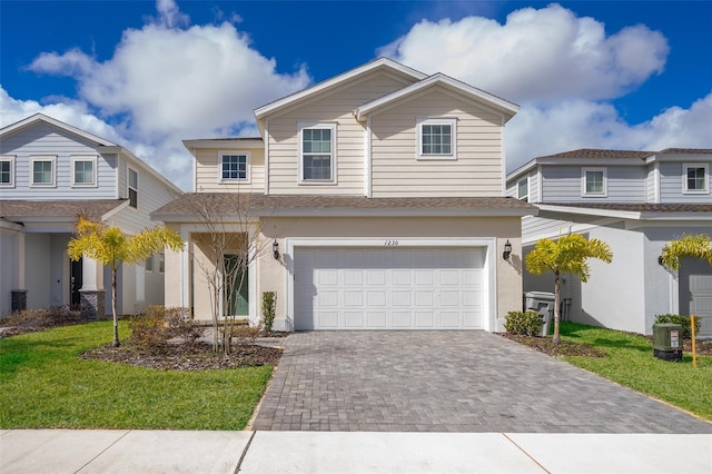 view of front of property featuring a front yard and a garage