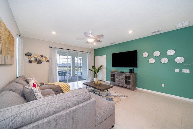 tiled living room featuring ceiling fan