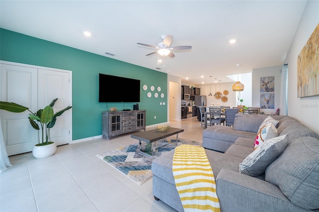 tiled living room with ceiling fan