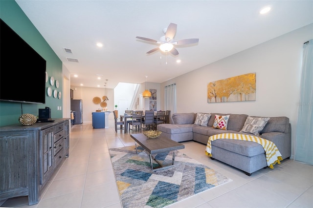 living room featuring light tile patterned floors and ceiling fan