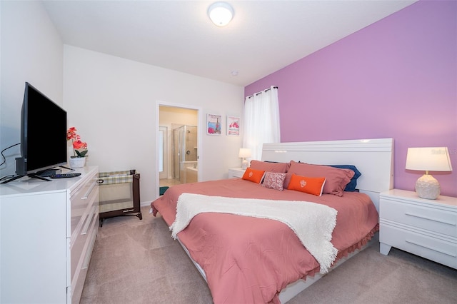 carpeted bedroom featuring ensuite bathroom