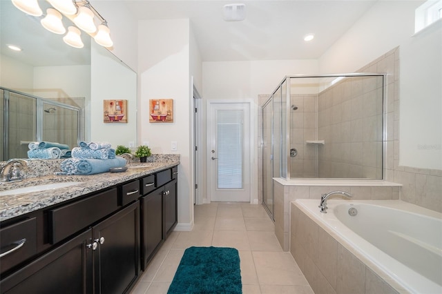 bathroom with tile patterned flooring, vanity, and separate shower and tub