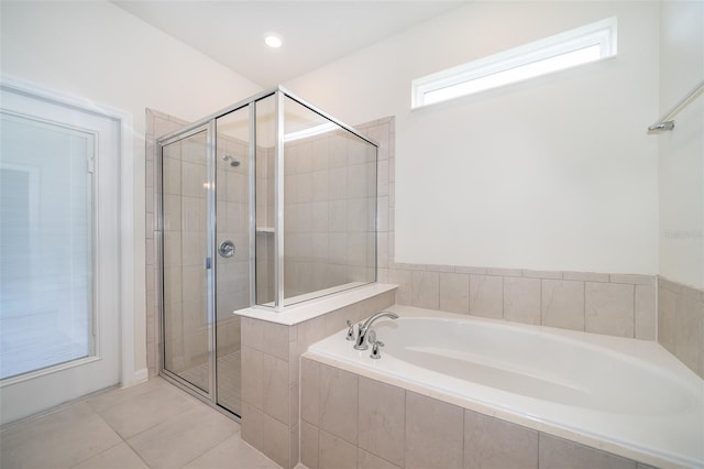 bathroom with separate shower and tub and tile patterned floors