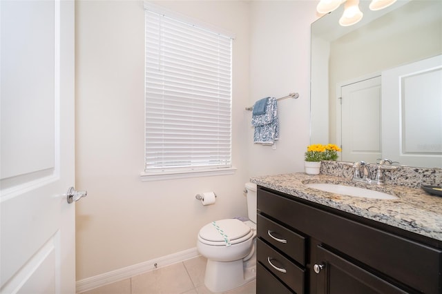 bathroom featuring tile patterned flooring, vanity, and toilet