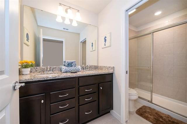 bathroom with tile patterned floors, vanity, walk in shower, and toilet