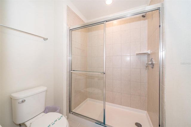 bathroom with toilet and an enclosed shower