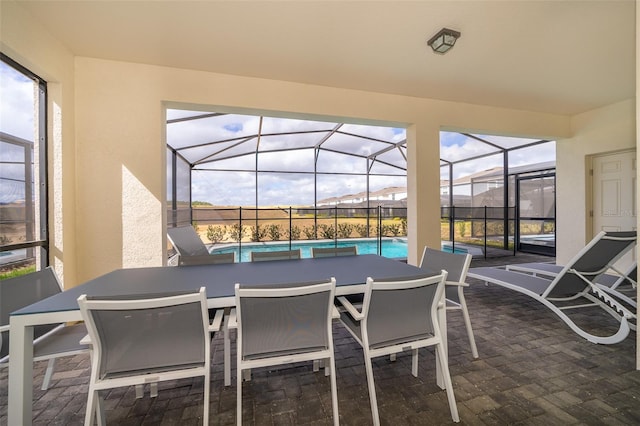 sunroom / solarium featuring plenty of natural light and a swimming pool