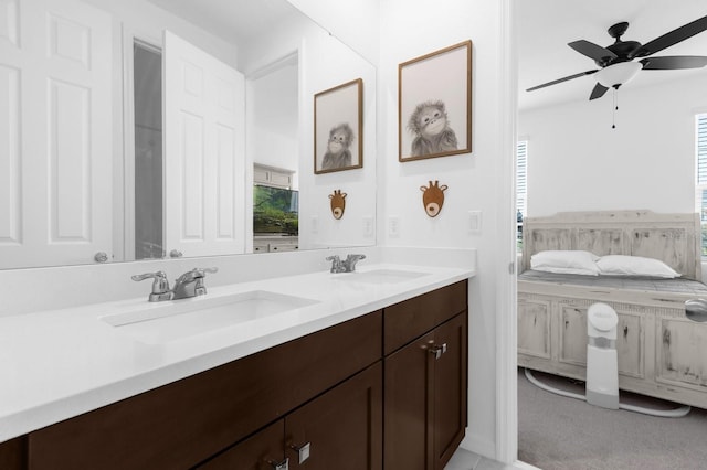 bathroom featuring double vanity, a healthy amount of sunlight, a ceiling fan, and a sink