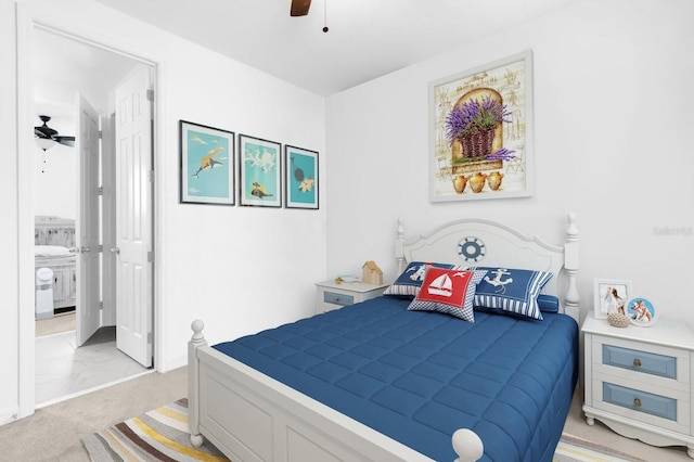 bedroom with light carpet, ceiling fan, and ensuite bathroom