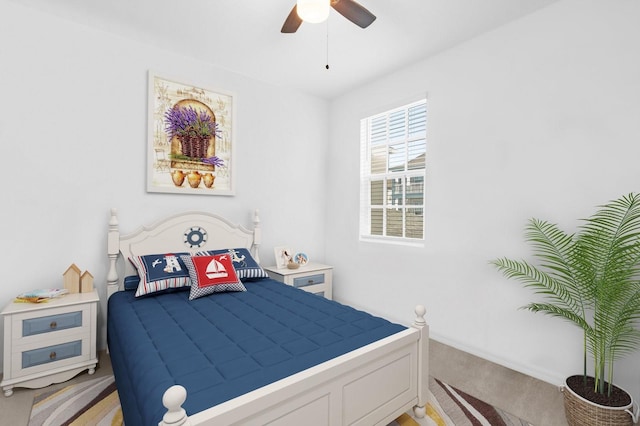 bedroom with a ceiling fan and light colored carpet